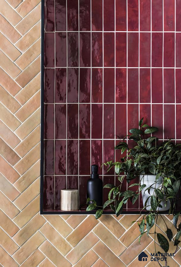 Charming Bathroom Detail Featuring Herringbone and Glossy Tile Accents with Lush Greenery | Material Depot