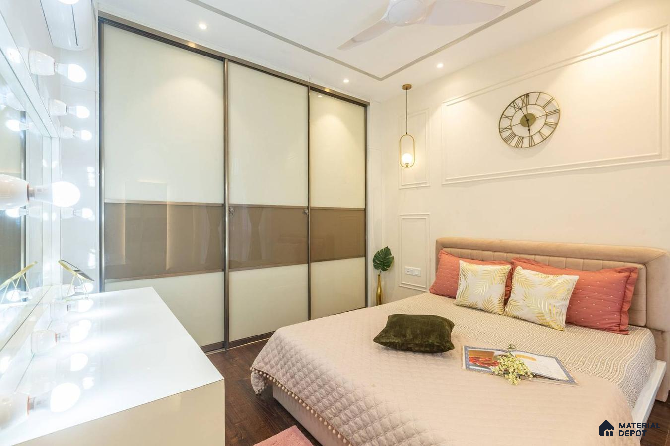 Bedroom with wooden laminate floor and glossy laminate closets