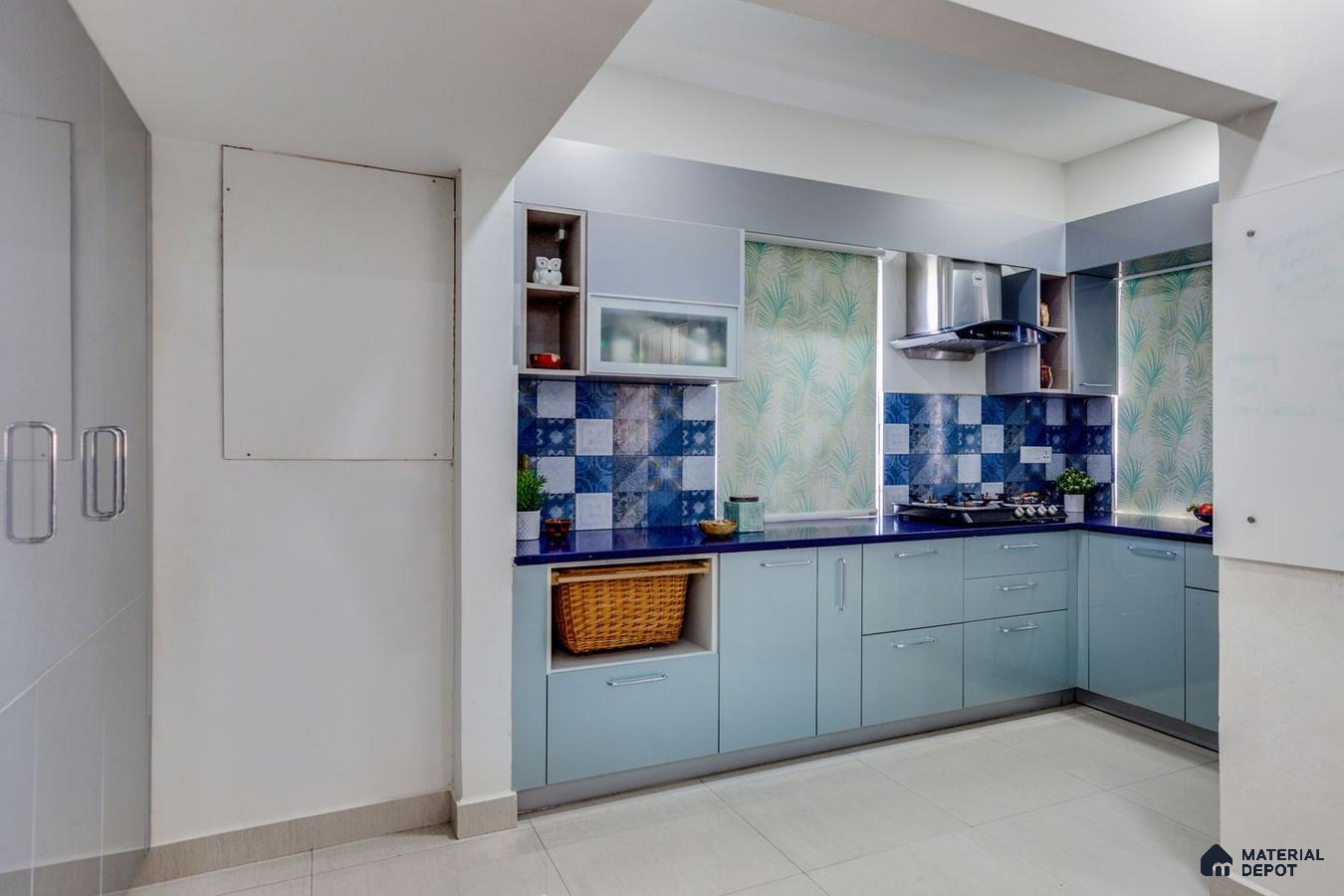 Stylish blue-themed kitchen in a Hyderabad 3 BHK flat.