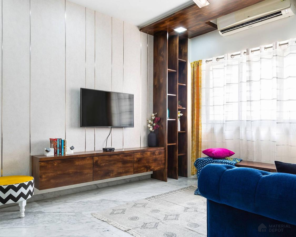 Chic living room with floating TV unit, blue sofa, air conditioning, and a curated display.
