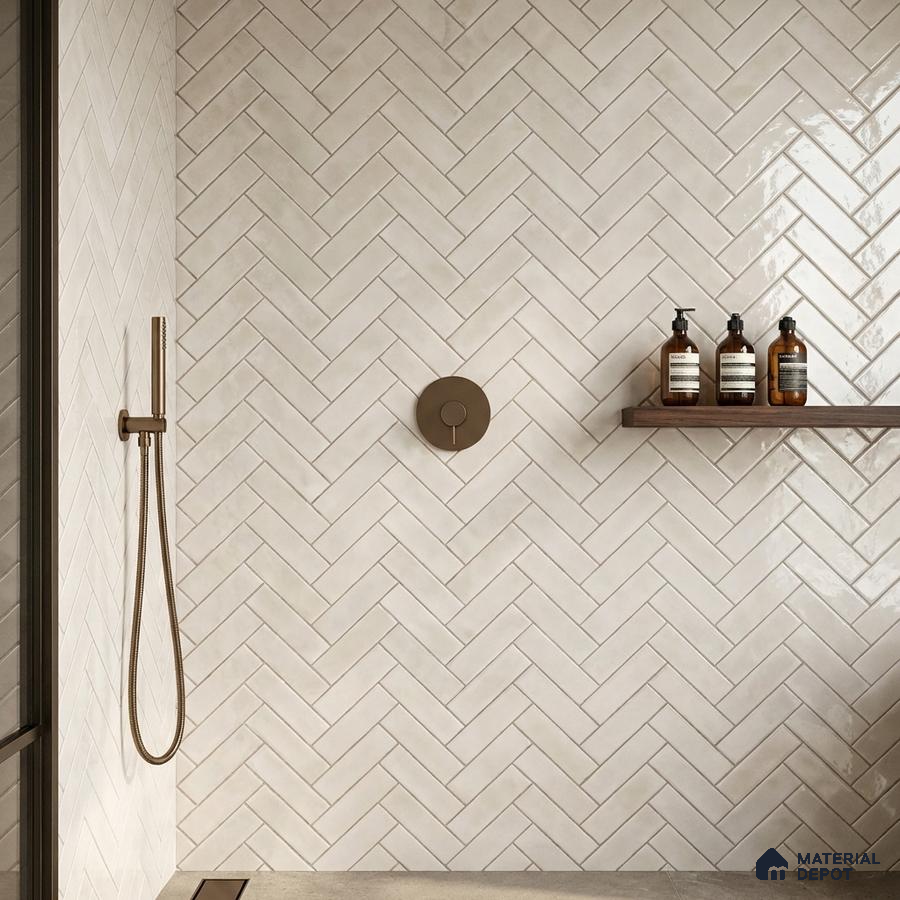 Minimalist bathroom with off-white herringbone subway wall tiles and matte beige floor tiles