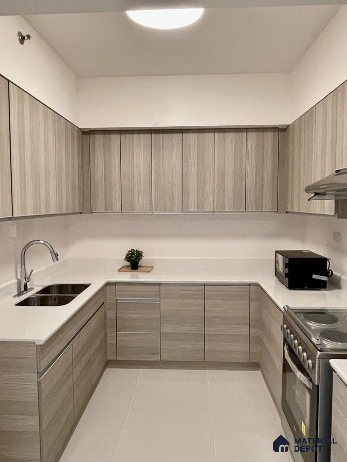 Minimalist kitchen with light oak wood grain laminate cabinets and white quartz countertop in Bengaluru | Material Depot