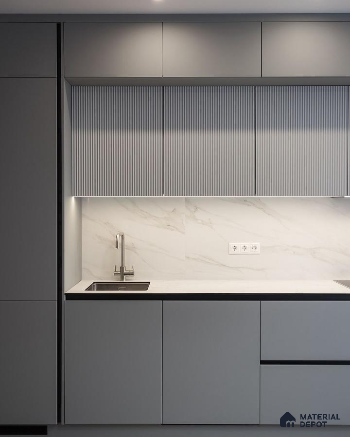 Minimalist kitchen with matte grey laminate, fluted upper cabinets, and white marble backsplash in Bengaluru | Material Depot