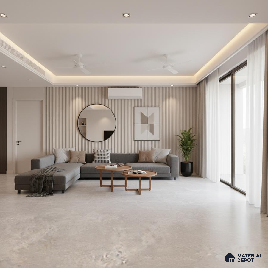 Minimalist living room with grey sectional, beige fluted wall panels, and light stone floor tiles in Bengaluru
