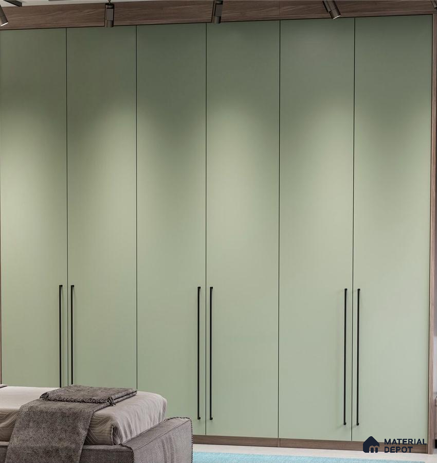 Minimalist sage green solid color laminate wardrobe with black handles in bedroom | Material Depot