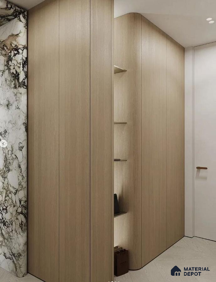 Minimalist Wardrobe with light oak laminate panels and dramatic marble accent wall | Material Depot