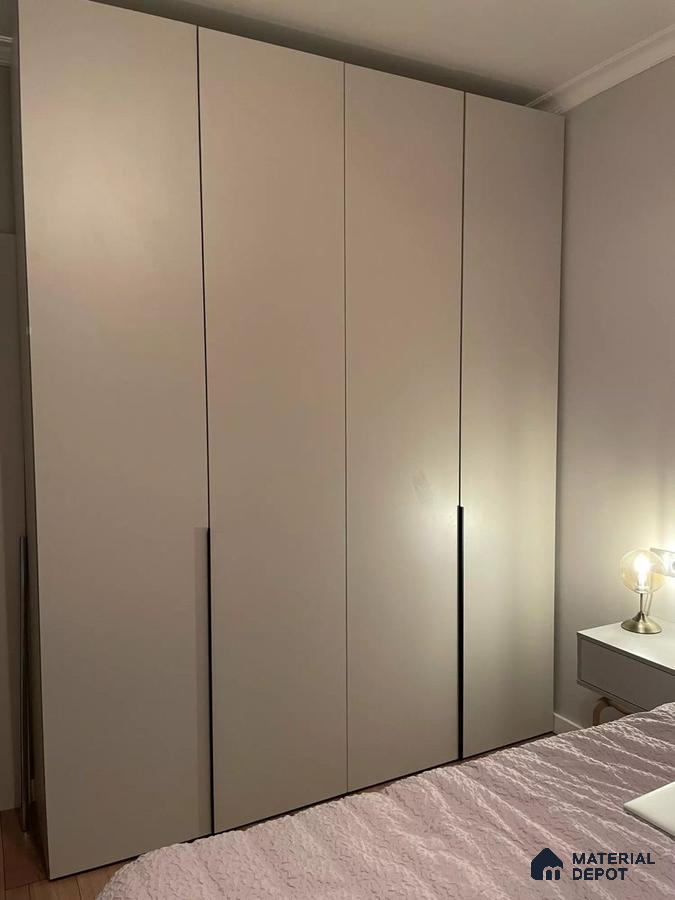 Minimalist wardrobe with matte beige laminate shutters in bedroom | Material Depot
