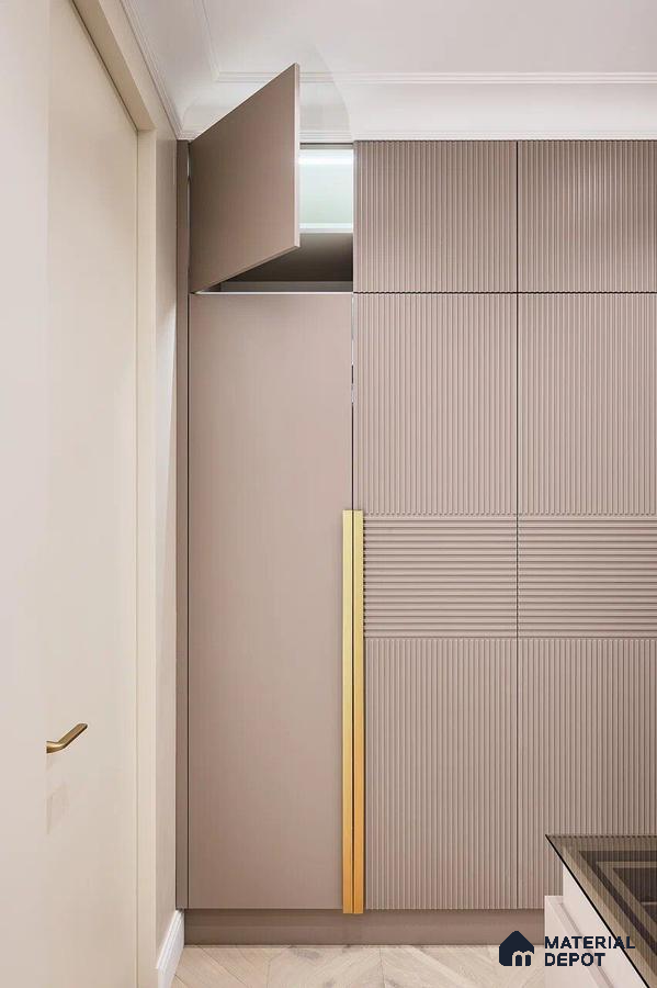 Minimalist wardrobe with taupe fluted laminate and gold accent handle | Material Depot