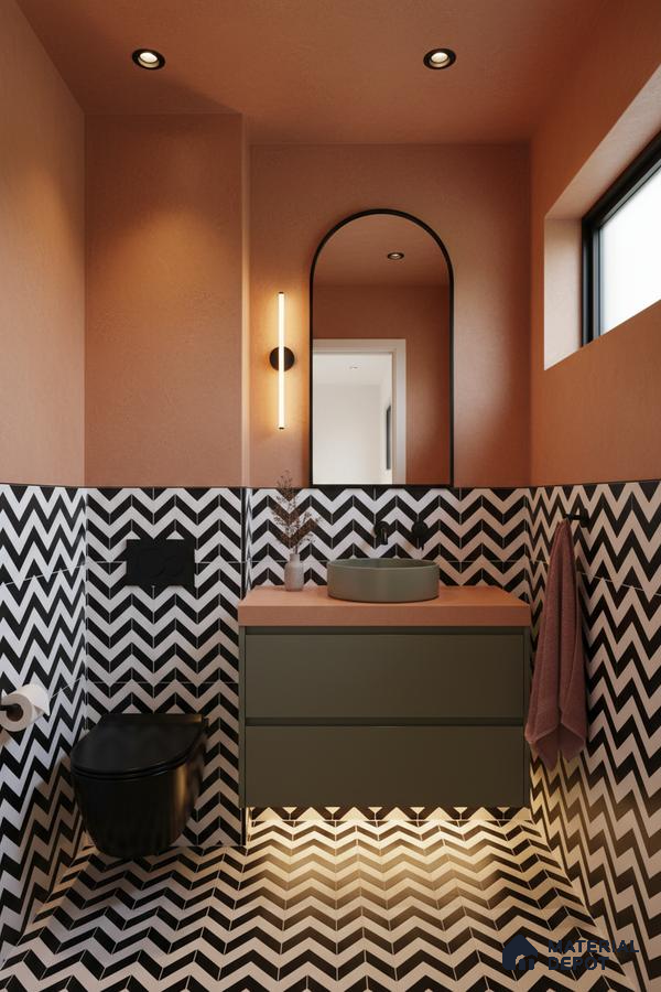 Modern bathroom with black-and-white chevron tiles, olive green vanity, and terracotta countertop in Bengaluru | Material Depot