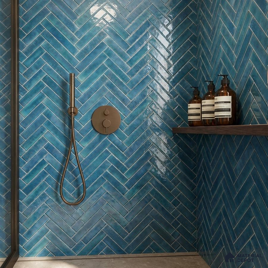 Modern bathroom with blue herringbone subway wall tiles and matte grey floor tile