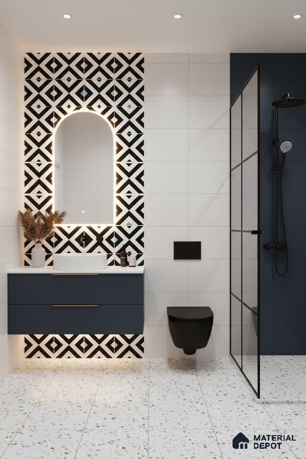 Modern bathroom with geometric black-and-white accent wall tiles, terrazzo floor tiles, and navy blue vanity in Bengaluru | Material Depot