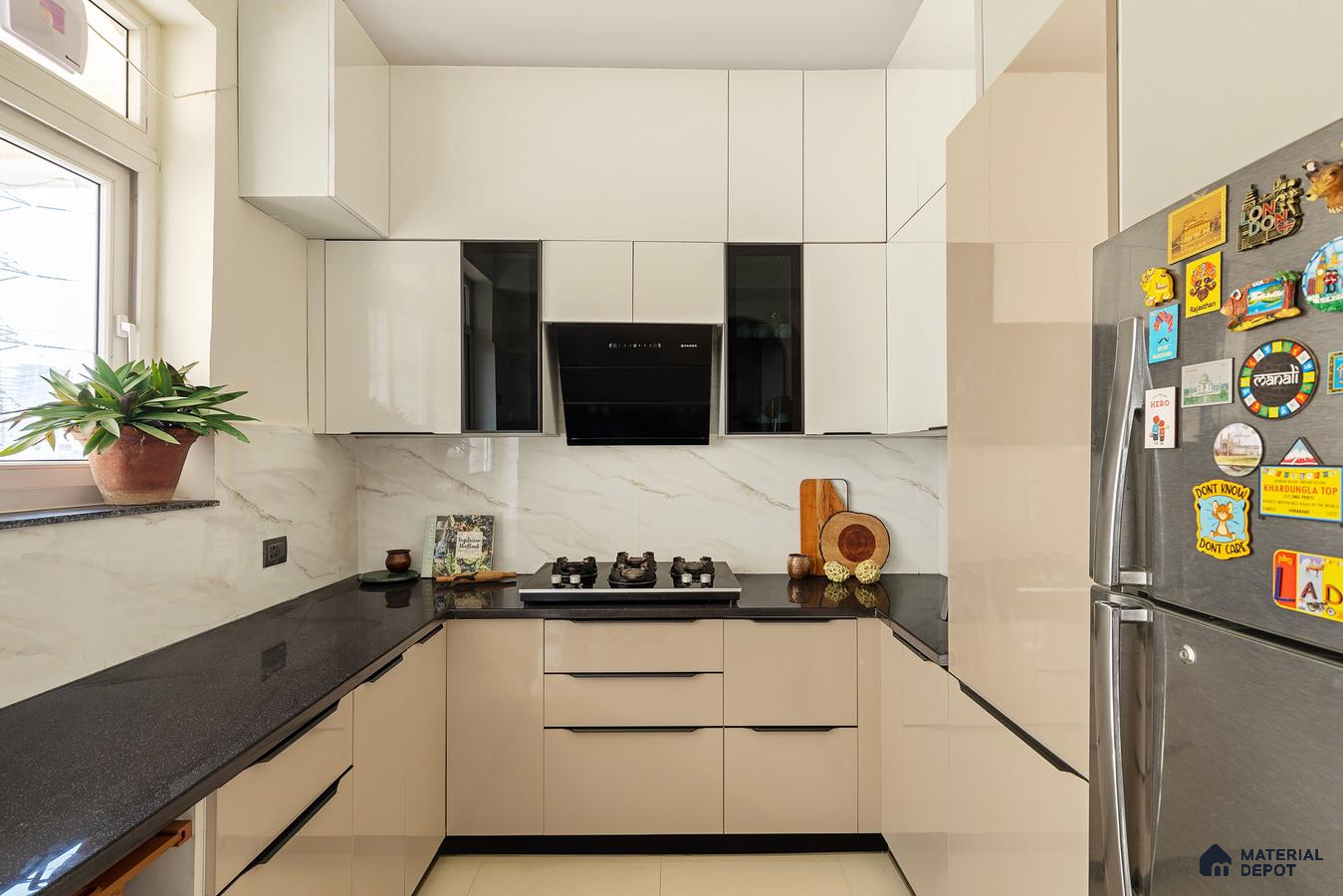 Modern kitchen with beige and frosty white high gloss laminate, black granite countertop, and marble-look backsplash in Bengaluru | Material Depot