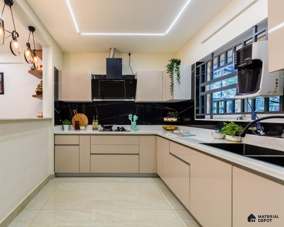Modern kitchen with beige high gloss laminate cabinets, black marble-look backsplash, and white quartz countertop in Bengaluru | Material Depot