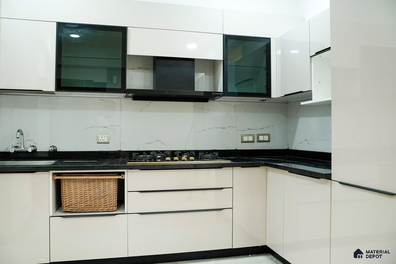 Modern kitchen with glossy white laminate cabinets, black granite countertop, and marble-look backsplash in Bengaluru | Material Depot