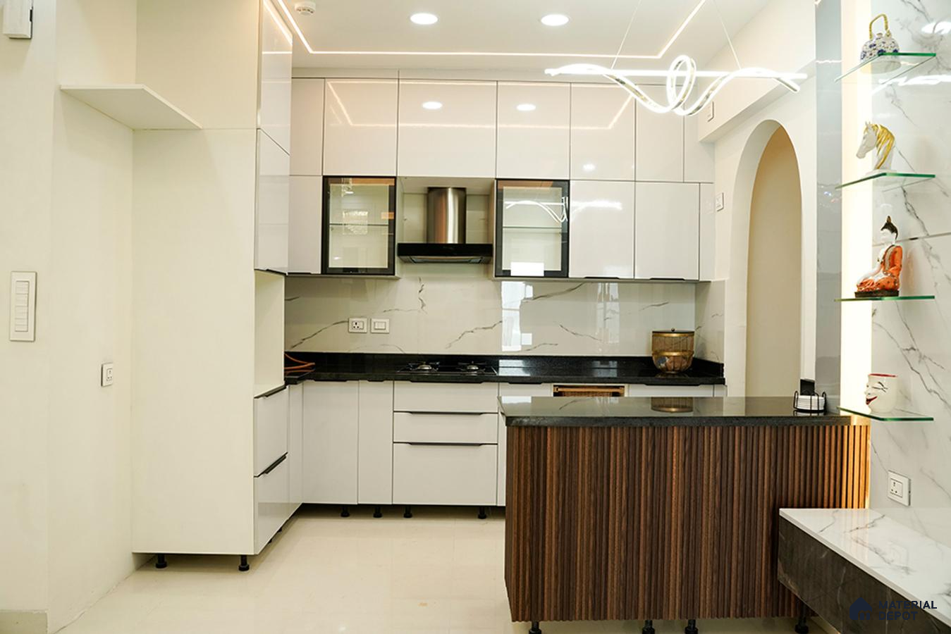 Modern kitchen with high gloss white laminate, black granite countertop, marble-look backsplash, and fluted wood island in Bengaluru | Material Depot
