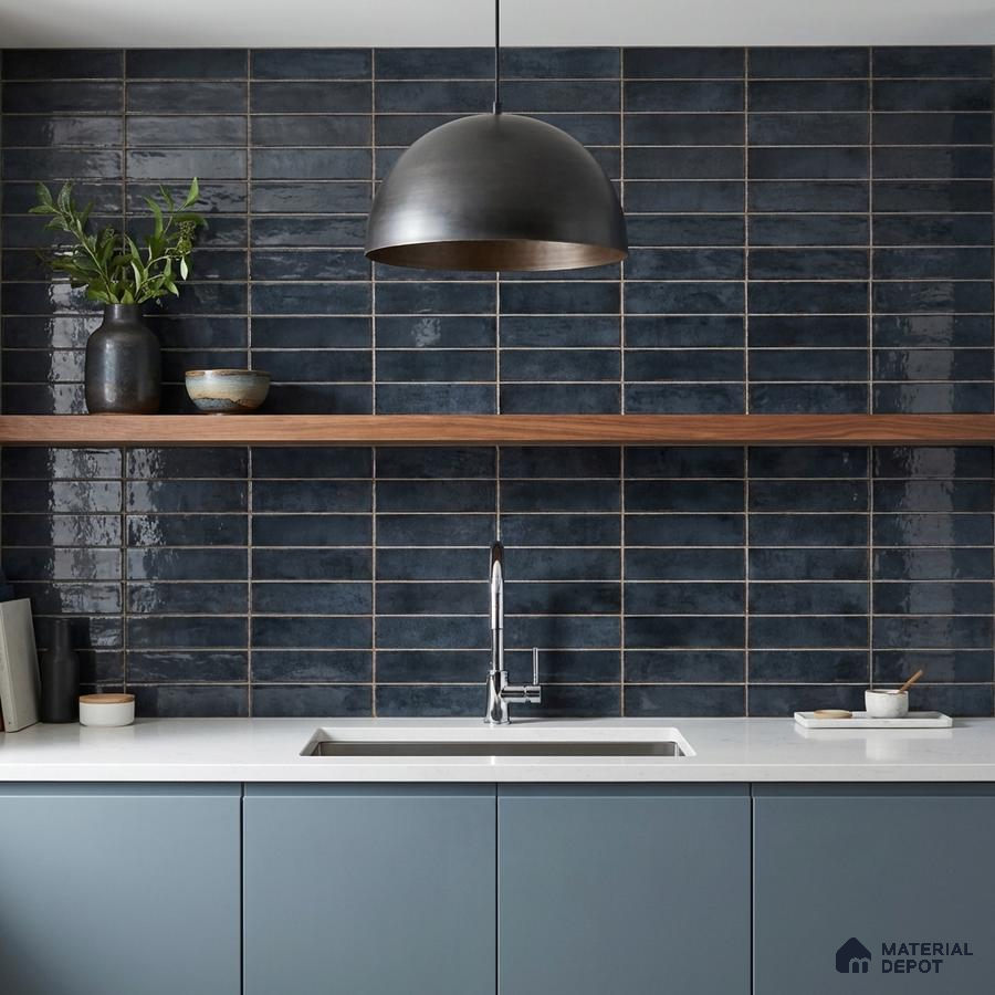 Modern kitchen with navy blue subway wall tiles, matte blue laminate cabinets, and white quartz countertop