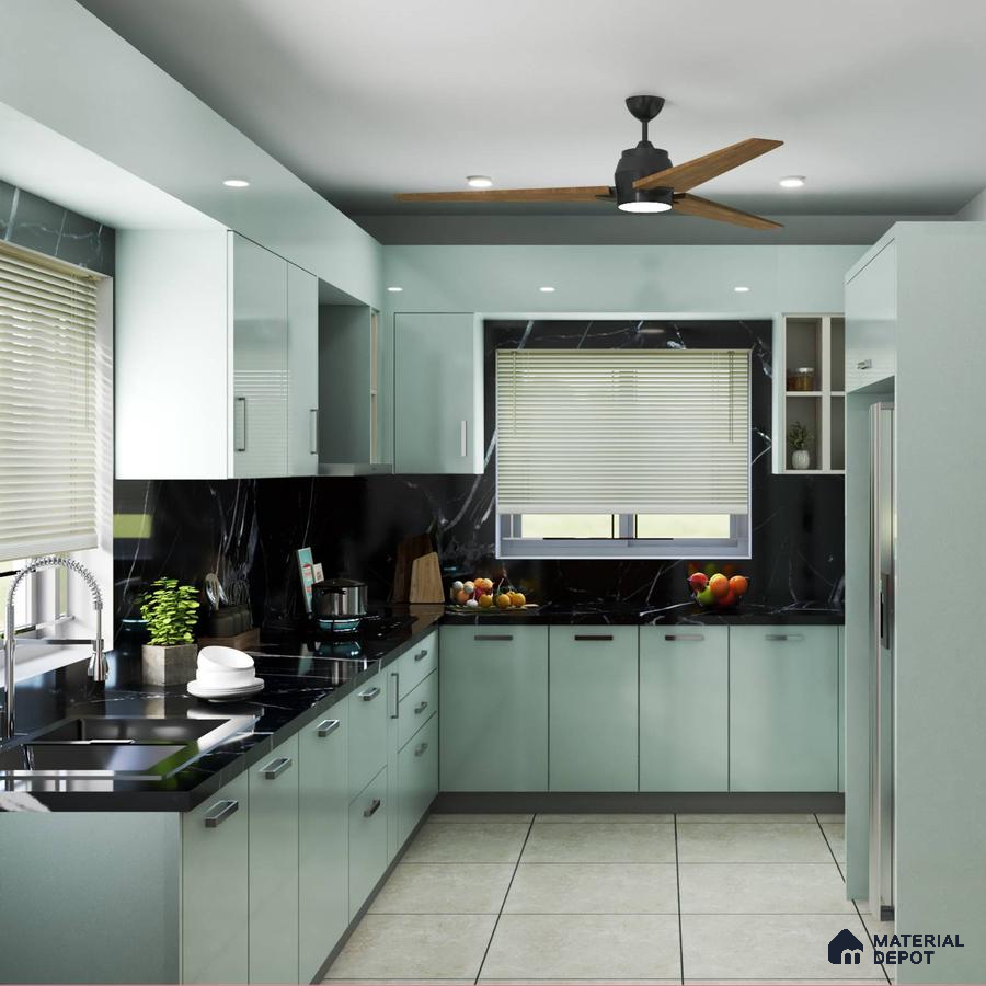 Modern kitchen with pastel green laminate cabinets and black marble-look backsplash in Bengaluru | Material Depot