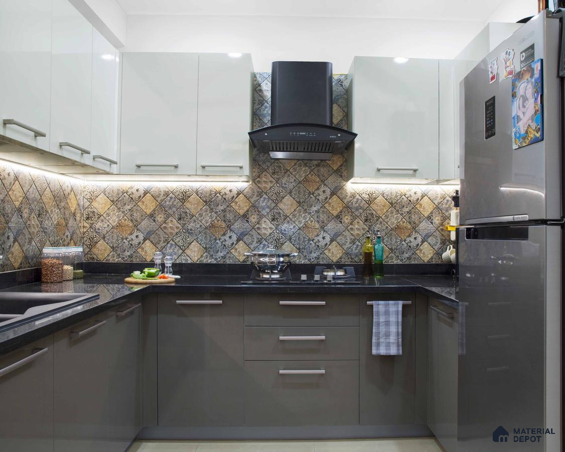 Modern kitchen with patterned moroccan backsplash tiles, glossy white and grey laminate cabinets, and black granite countertop in Bengaluru | Material Depot