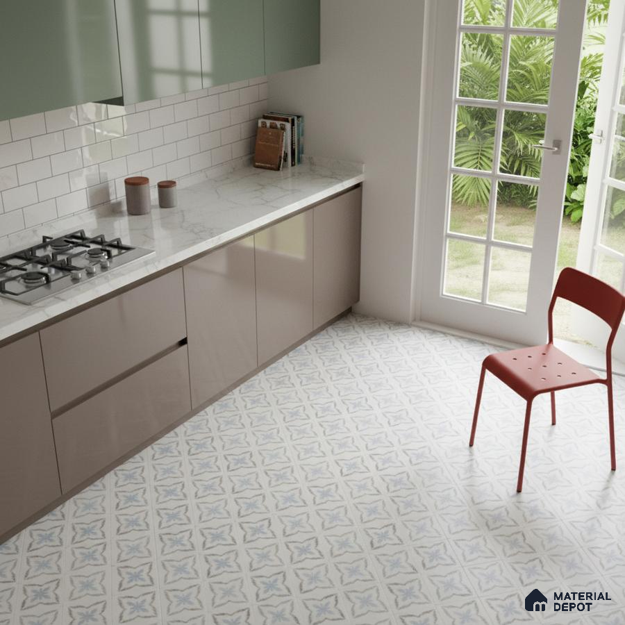 Modern kitchen with sage green and taupe laminate, white marble countertop, and blue patterned floor tiles in Bengaluru