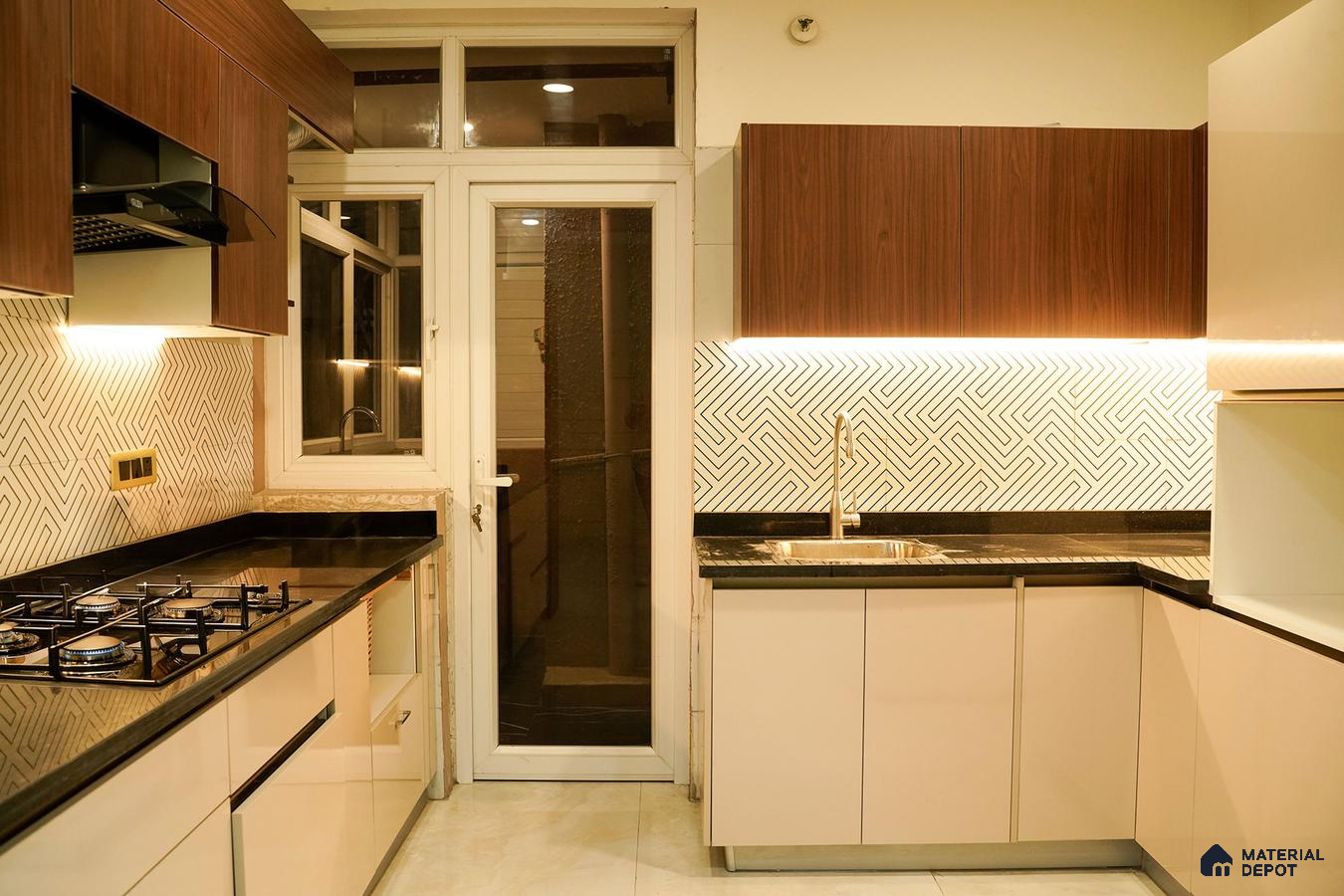 Modern kitchen with walnut wood laminate, beige high gloss laminate, black granite countertop, and geometric backsplash tiles in Bengaluru | Material Depot