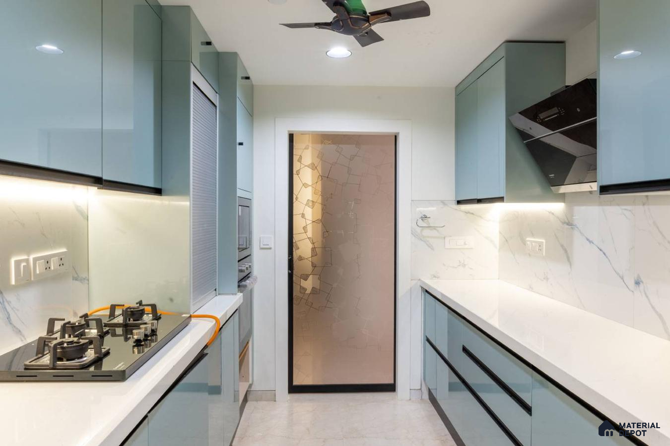 Modern parallel kitchen with pastel blue high gloss laminate, white quartz countertop, and marble-look backsplash in Bengaluru | Material Depot