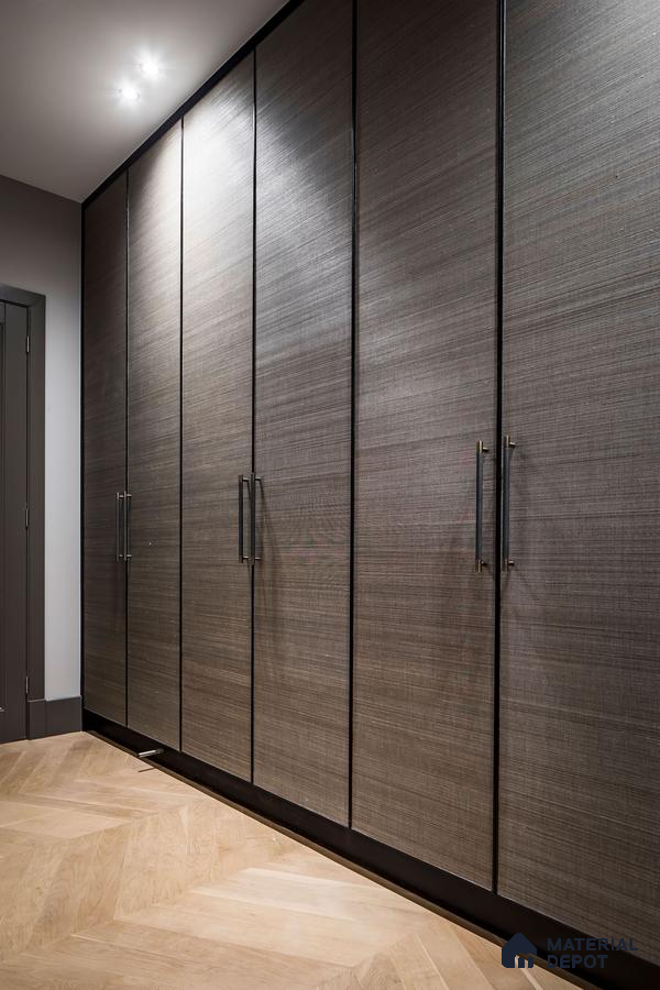 Modern wardrobe with textured grey laminate shutters and light oak herringbone wooden flooring | Material Depot