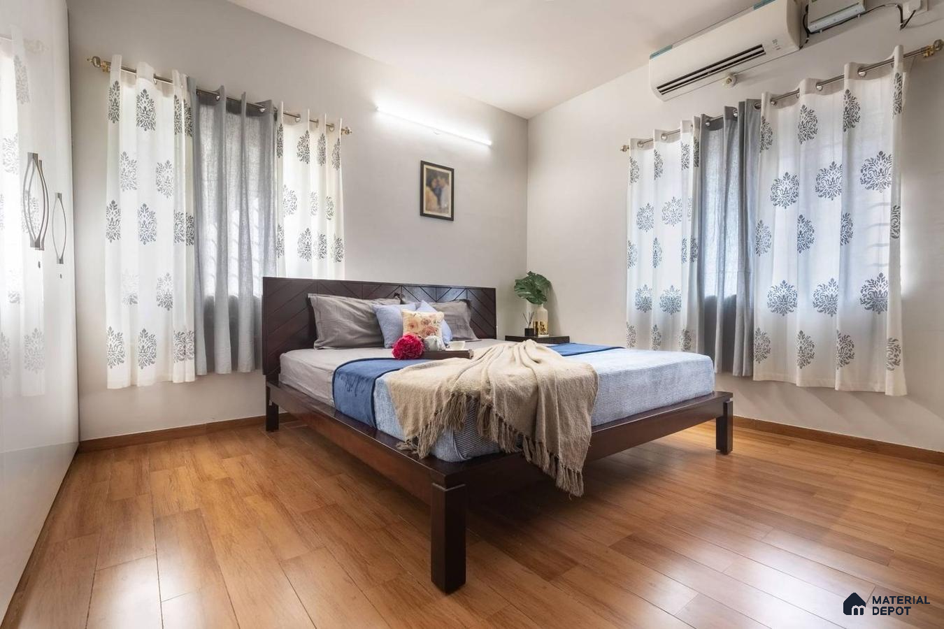 Master bedroom with wooden laminate flooring and light grey walls