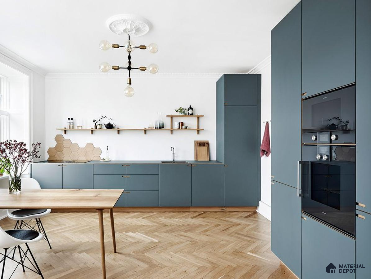 Scandinavian kitchen with matte blue laminate cabinets and herringbone oak wooden flooring in Bengaluru | Material Depot