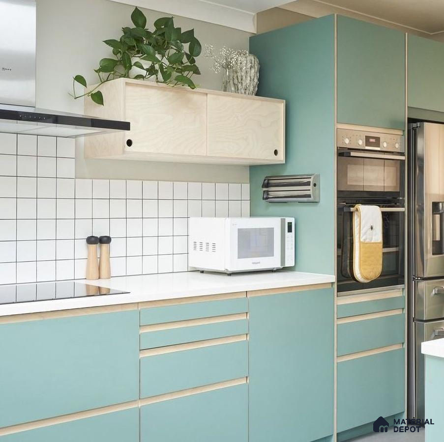 Scandinavian kitchen with pastel green laminate cabinets, birch wood accents, and white quartz countertop in Bengaluru | Material Depot