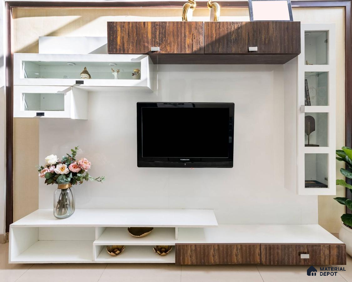 Foyer with a laminate finish TV unit, large TV fixed on the panel, adorned with a floral vase, and enhanced by wooden detailing.