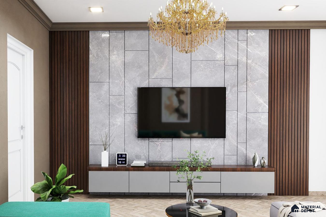 Room with a contemporary TV unit, grey stone panel behind the big TV, and a beautiful chandelier for added elegance.