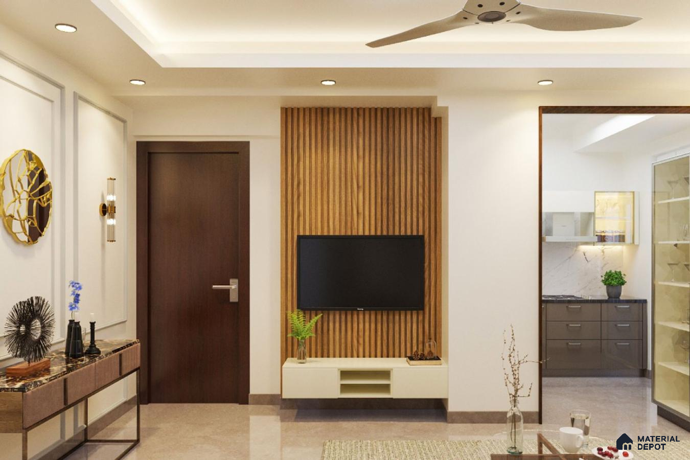 Room with a wooden wall and a gold mirror, a wooden console table with blue vases and a potted plant, a ceiling fan and a flat-screen TV