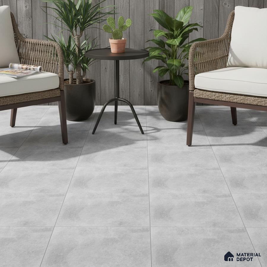 Scandinavian outdoor seating with grey stone-look floor tiles and weathered wood wall panels