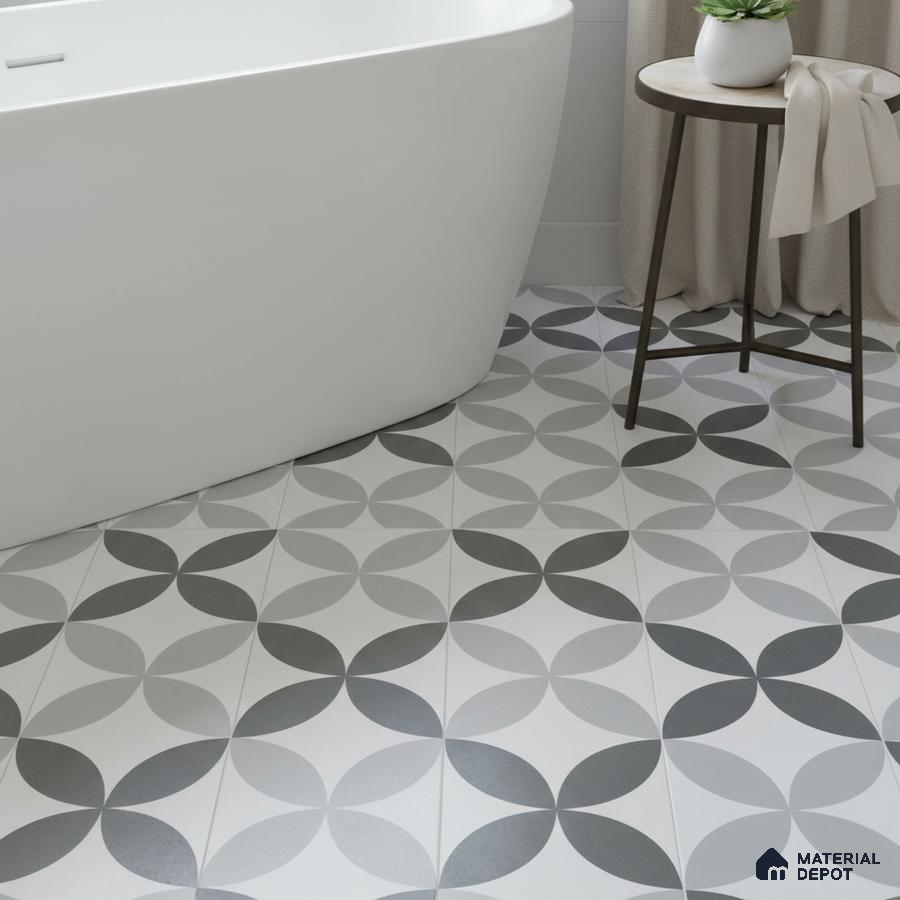 Modern bathroom with geometric black-and-grey patterned floor tiles and freestanding tub