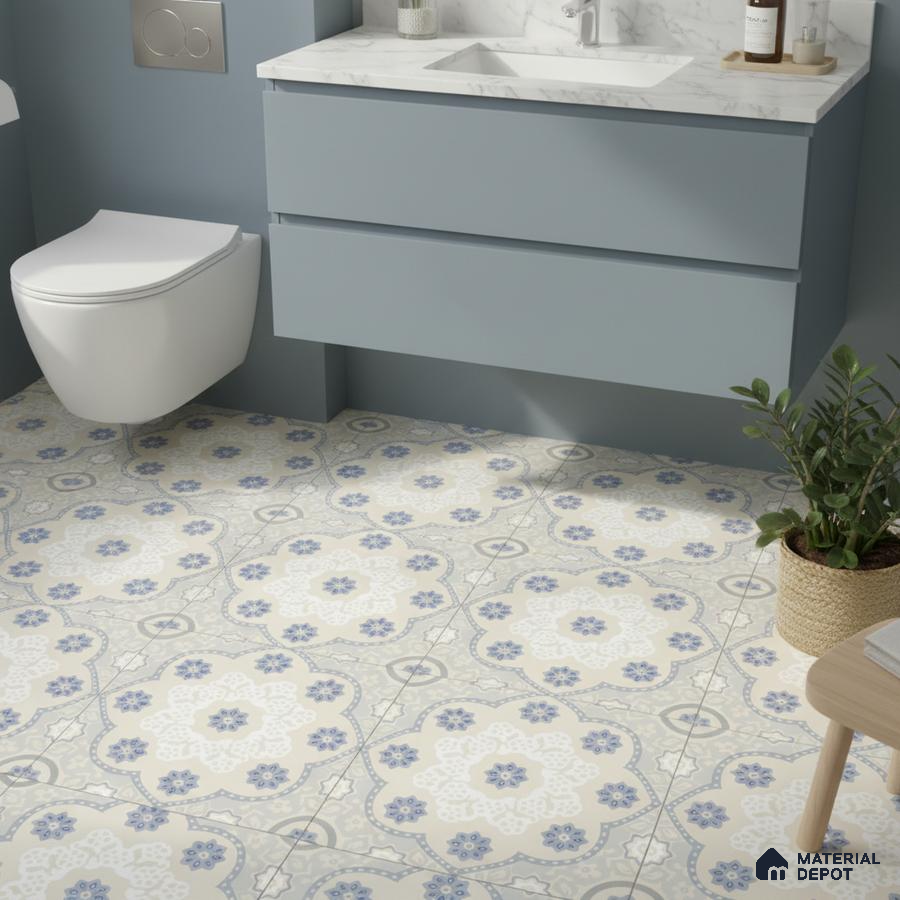Modern bathroom with blue vanity, white marble countertop, and blue floral patterned floor tiles