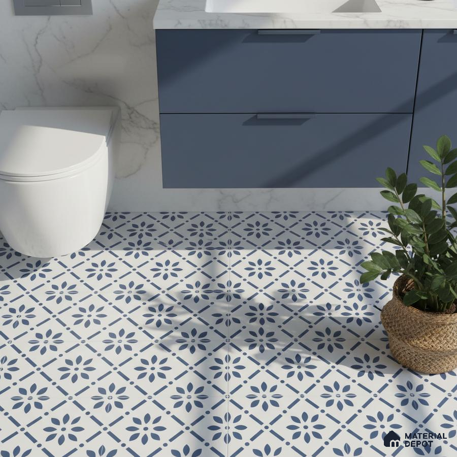 Modern bathroom with blue vanity, marble wall, and blue-and-white floral patterned floor tiles