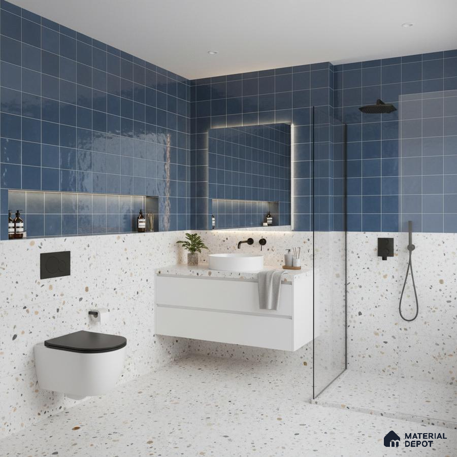 Modern kitchen with blue square wall tiles, blue laminate cabinets, and black marble countertop