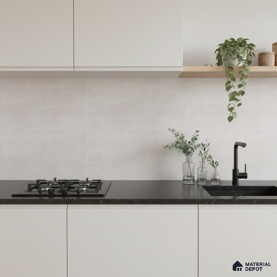 Minimalist kitchen with frosty white laminate cabinets, matte black quartz countertop, and light grey stone backsplash tile