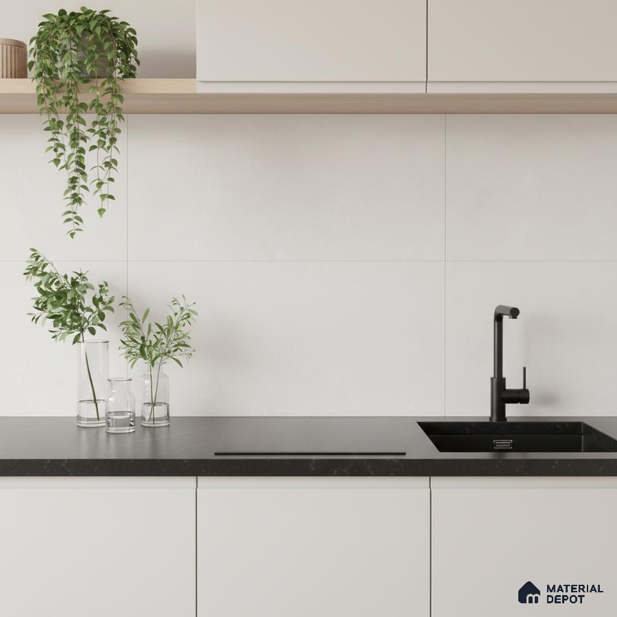 Minimalist kitchen with frosty white laminate cabinets and matte black quartz countertop