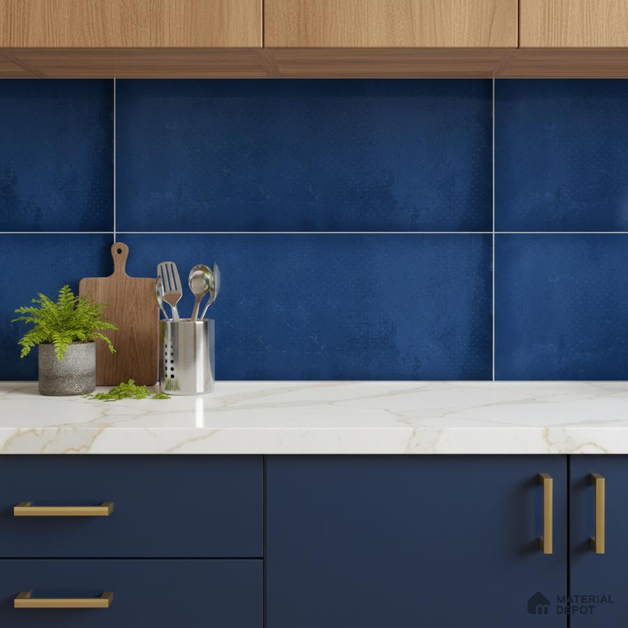 Modern kitchen with navy blue laminate cabinets, white marble-look quartz countertop, and blue ceramic backsplash tiles