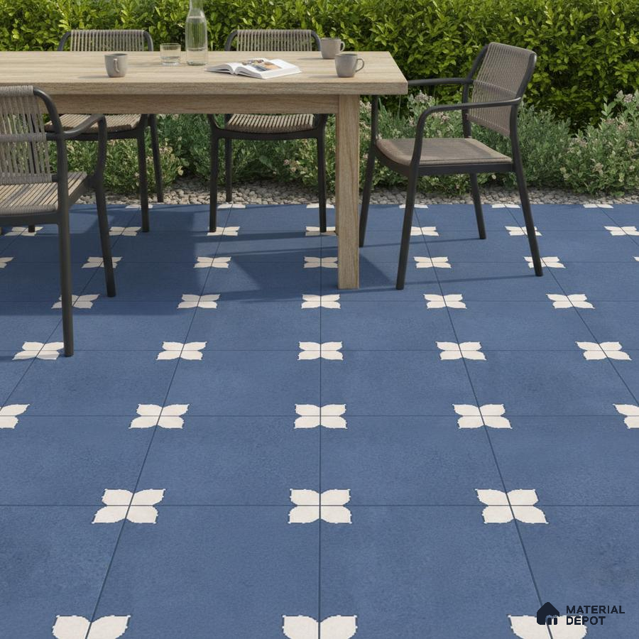 Modern outdoor dining with blue geometric patterned floor tiles and natural wood table