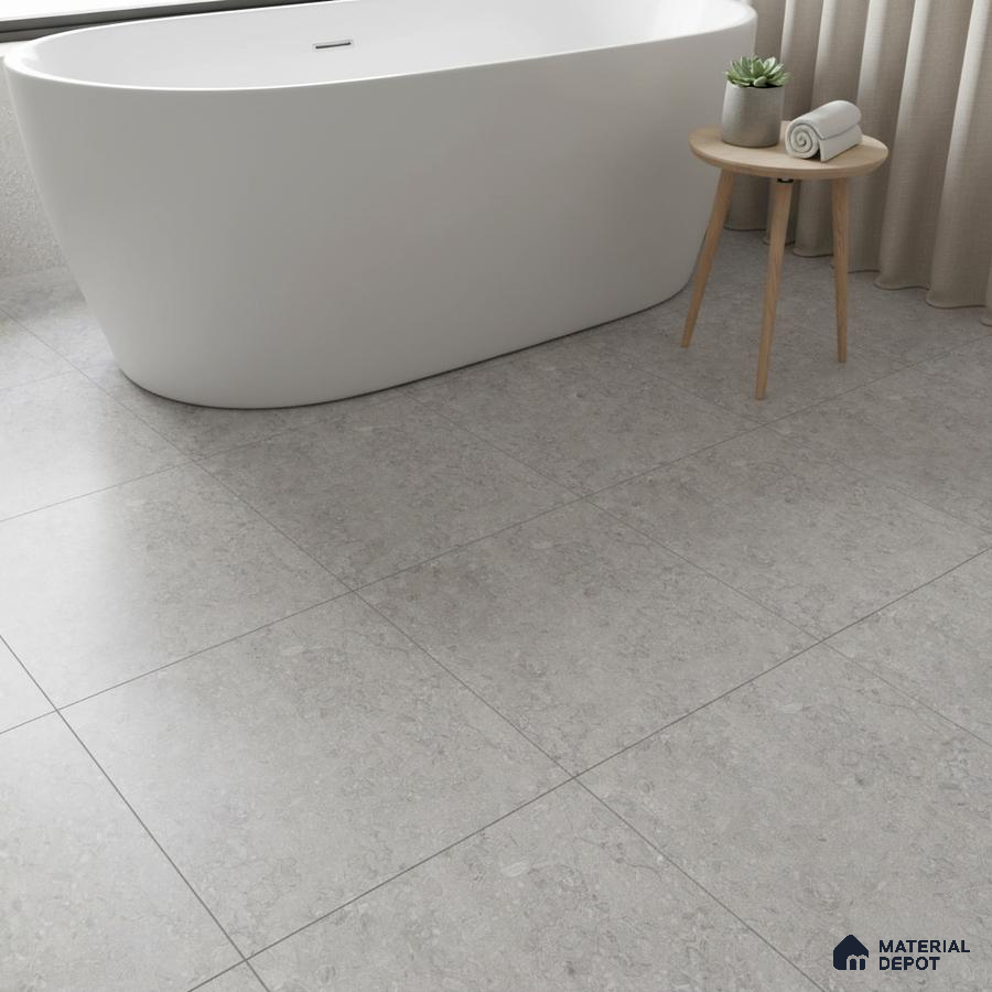 Minimalist bathroom with light grey stone-look floor tiles and freestanding tub