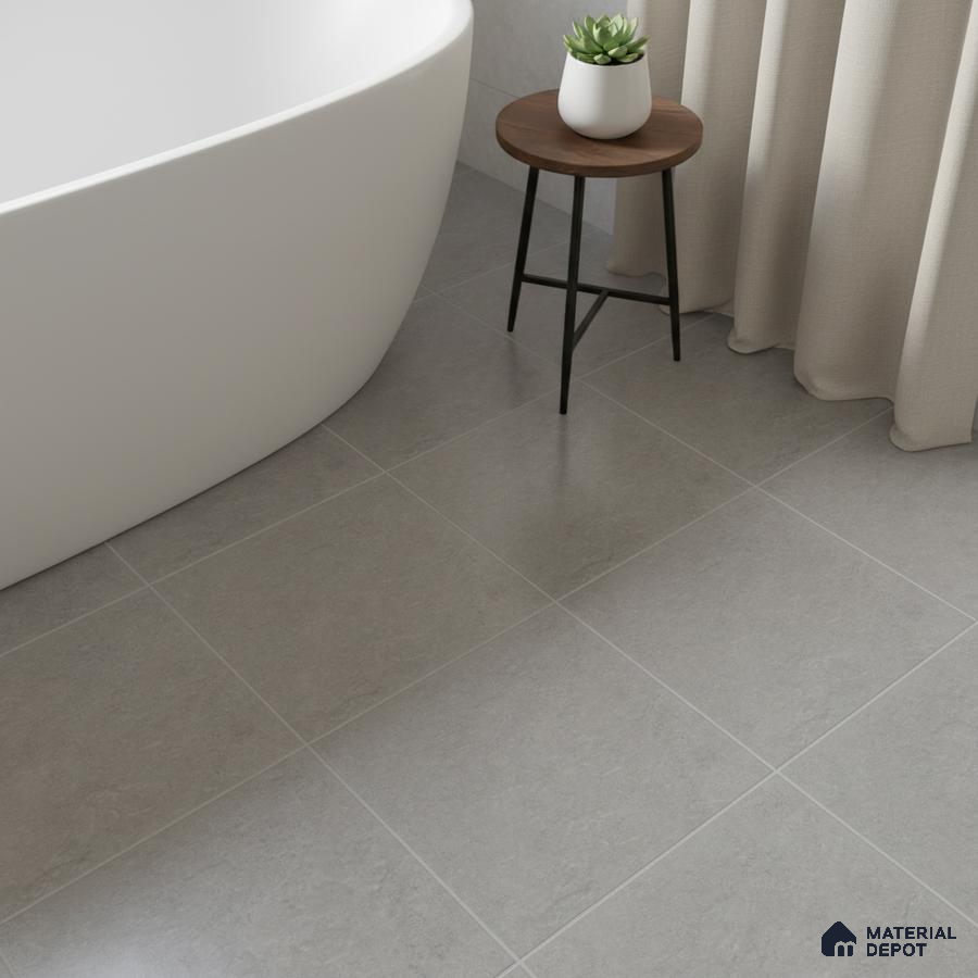 Minimalist bathroom with matte grey stone-look floor tiles and freestanding tub
