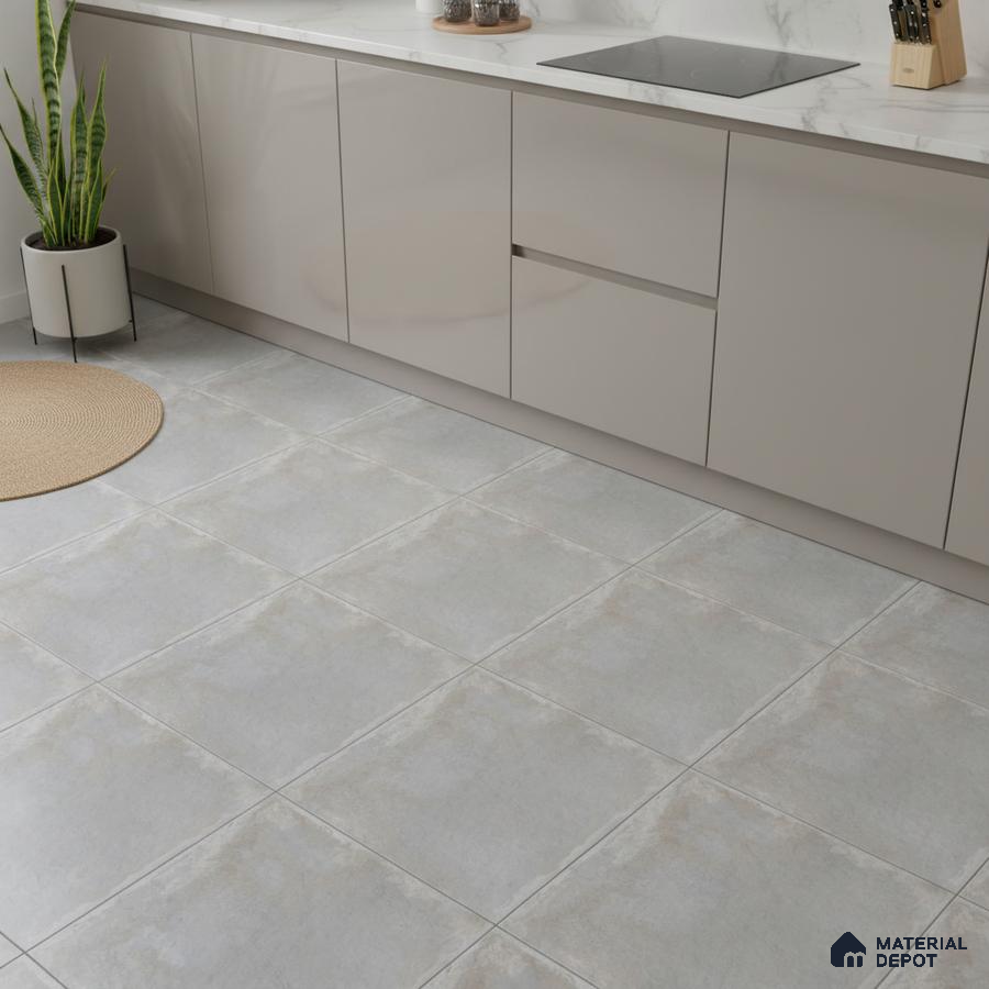 Modern kitchen with beige matte laminate cabinets, white marble-look countertop, and light grey stone floor tiles