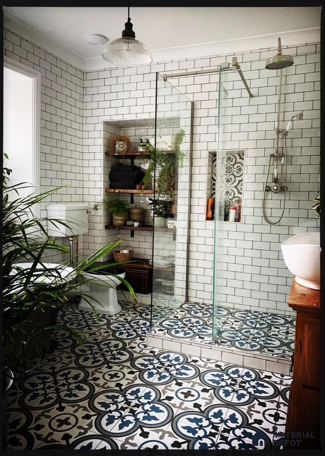 Vintage Charm: Classic Subway Tiles with Ornate Patterned Flooring in a Lush Bathroom Retreat | Material Depot
