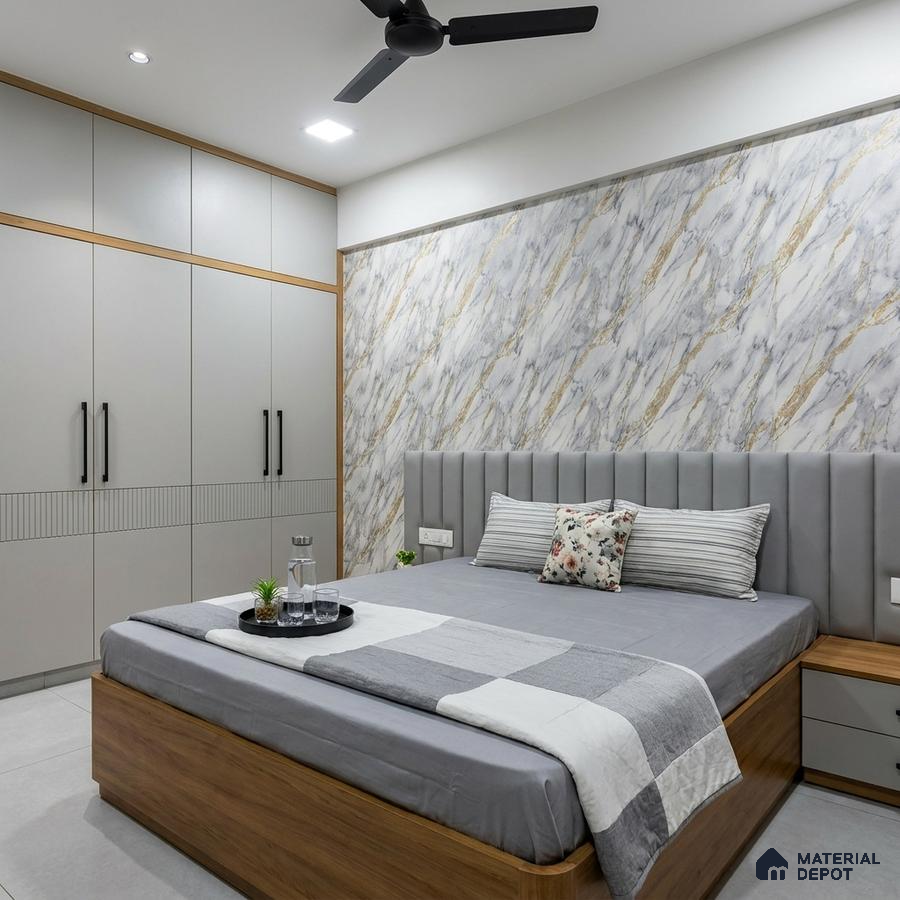 Modern bedroom with marble-look accent wall, grey upholstered headboard, and dual tone wardrobe